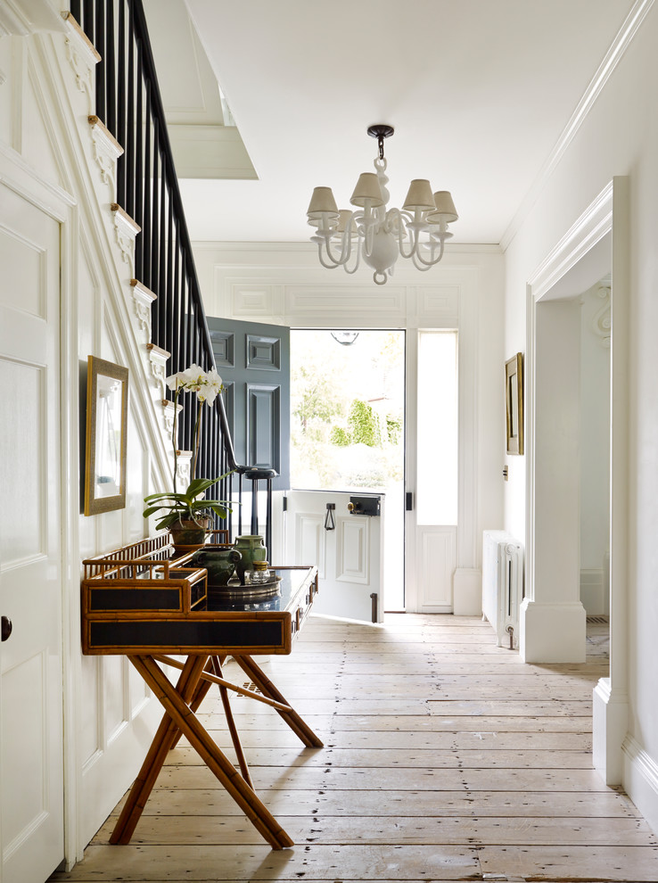 Mid-sized traditional foyer in New York with white walls, light hardwood floors, a gray front door, beige floor and a dutch front door.
