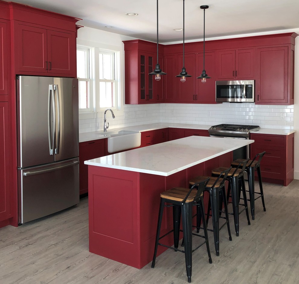 Inspiration for a kitchen in Other with a single-bowl sink, shaker cabinets, red cabinets, quartz benchtops, porcelain splashback, stainless steel appliances and white benchtop.