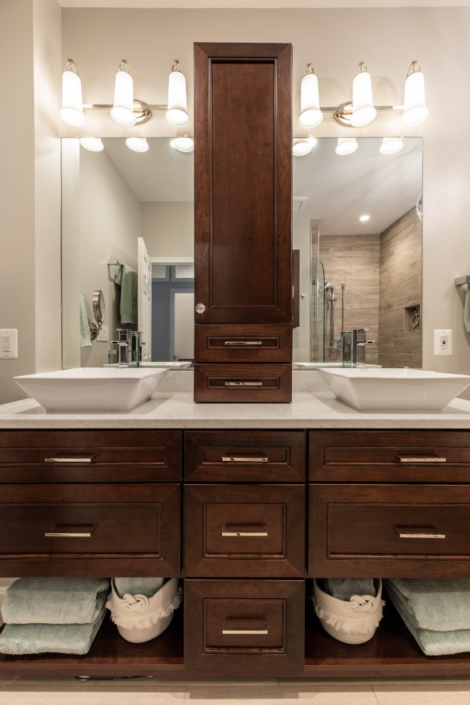 Inspiration for a large contemporary bathroom in DC Metro with glass-front cabinets, white cabinets, dark hardwood flooring and brown floors.