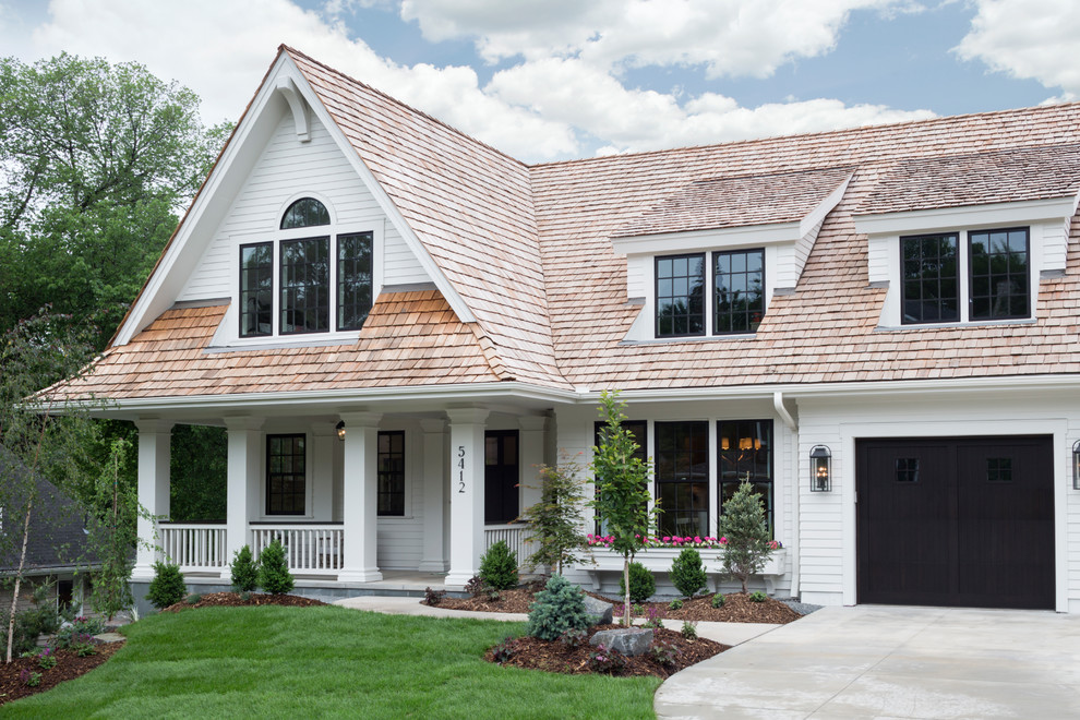 Inspiration for a traditional two-storey white house exterior in Minneapolis with a gable roof and a shingle roof.