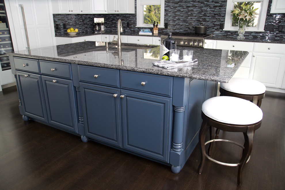 This is an example of an expansive u-shaped kitchen in Boston with an undermount sink, granite benchtops, blue splashback, stainless steel appliances, raised-panel cabinets, blue cabinets, dark hardwood floors and with island.