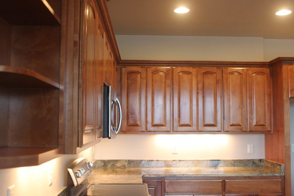 Inspiration for a large contemporary l-shaped dark wood floor and brown floor kitchen remodel with raised-panel cabinets, medium tone wood cabinets, granite countertops, stainless steel appliances and an island