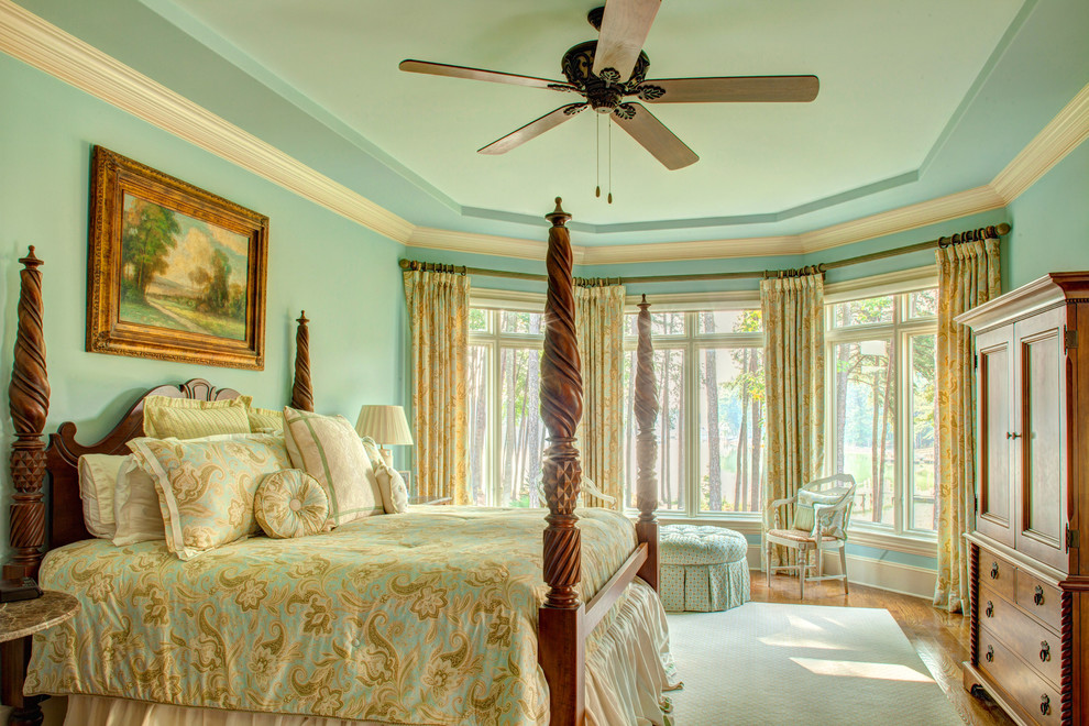 Inspiration for a timeless medium tone wood floor bedroom remodel in Charlotte with blue walls