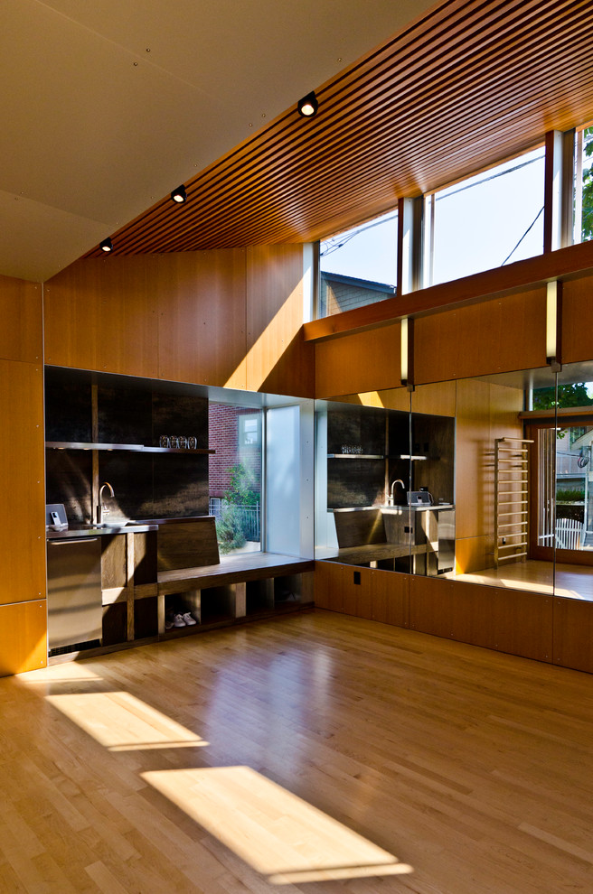 Example of a minimalist light wood floor home gym design in Seattle