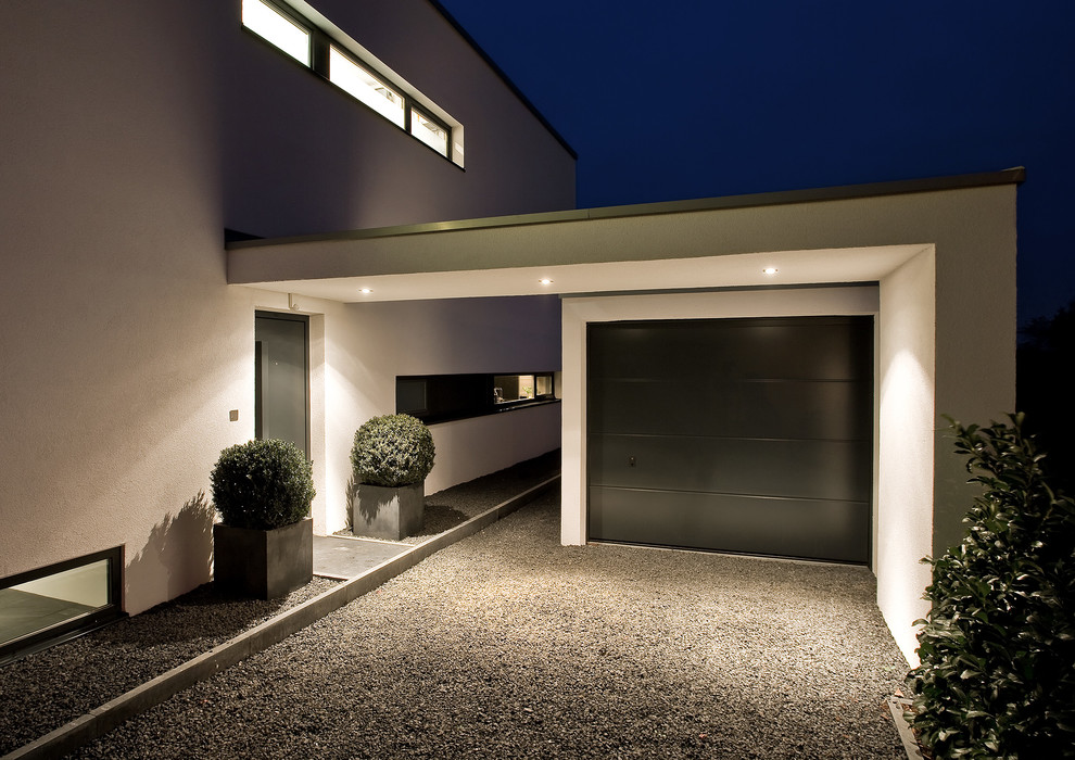 Design ideas for a mid-sized modern attached garage in Dusseldorf.