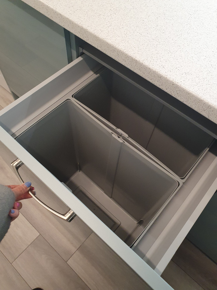 Inspiration for a small modern u-shaped enclosed kitchen in West Midlands with an integrated sink, flat-panel cabinets, blue cabinets, laminate countertops, stainless steel appliances, laminate floors, no island, grey floors and multicoloured worktops.