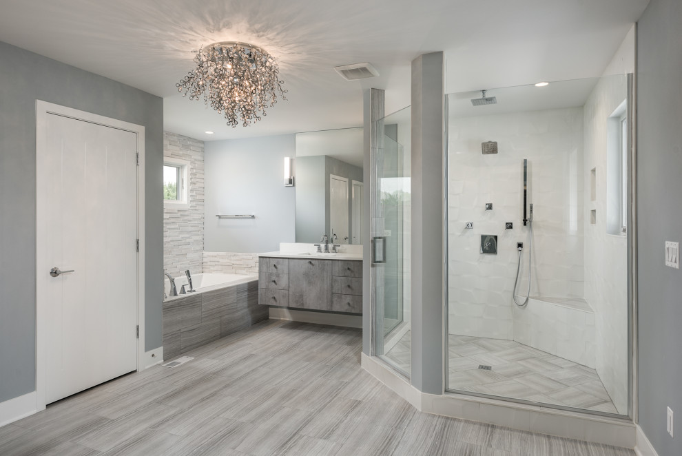 Design ideas for a large modern master bathroom in Chicago with flat-panel cabinets, grey cabinets, a two-piece toilet, ceramic floors, a drop-in sink, engineered quartz benchtops, grey floor, white benchtops, a built-in vanity, a drop-in tub, a corner shower, white tile, grey walls, a hinged shower door, a shower seat, ceramic tile and a double vanity.