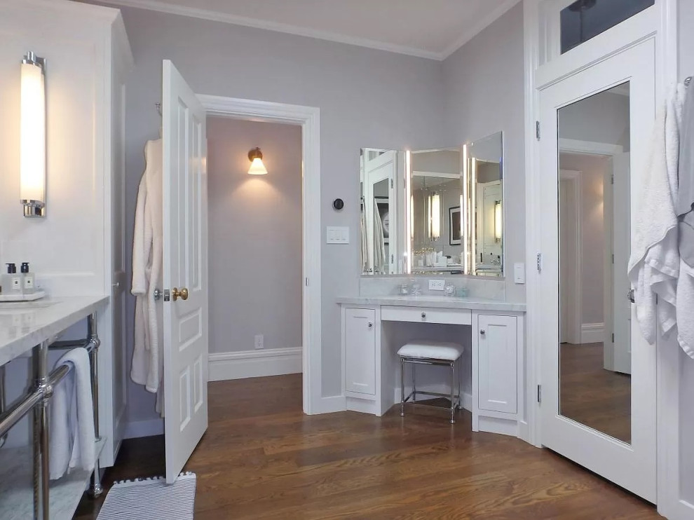 Example of a large ornate master stone slab medium tone wood floor, double-sink and wall paneling bathroom design in San Francisco with shaker cabinets, white cabinets, a one-piece toilet, an undermount sink, marble countertops, white countertops and a built-in vanity
