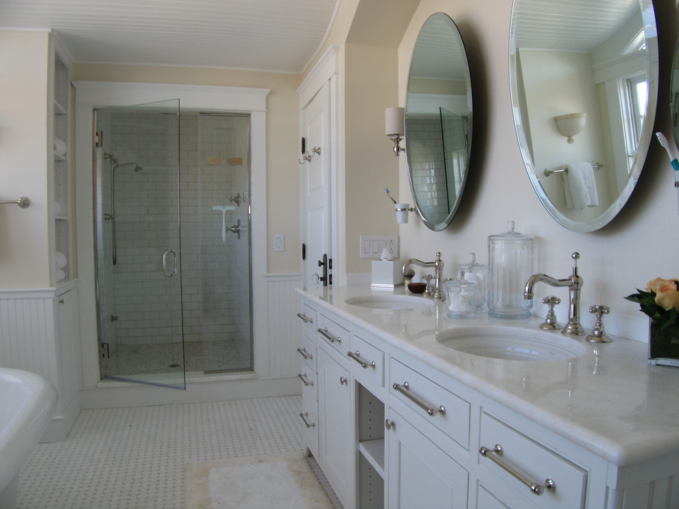 Photo of a mid-sized traditional master bathroom in Burlington with shaker cabinets, white cabinets, a claw-foot tub, an alcove shower, a two-piece toilet, white tile, subway tile, yellow walls, linoleum floors, an undermount sink, soapstone benchtops, multi-coloured floor and a hinged shower door.