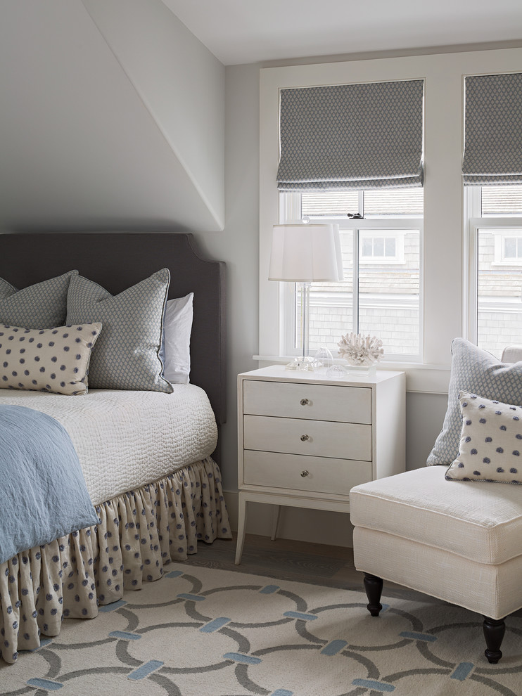 This is an example of a transitional guest bedroom in Boston with grey walls.