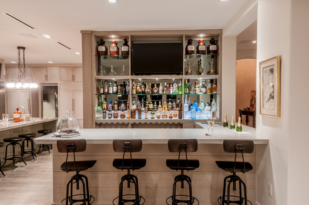 This is an example of a large contemporary galley seated home bar in Miami with an integrated sink, flat-panel cabinets, light wood cabinets, concrete benchtops, mirror splashback and dark hardwood floors.
