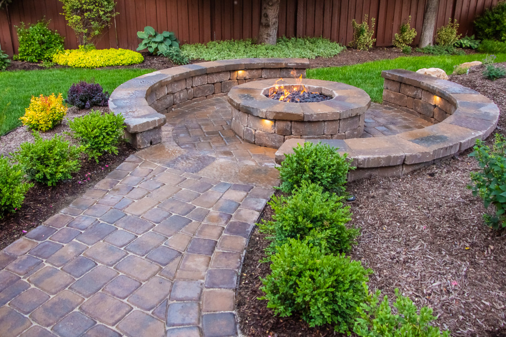 Inspiration for a mid-sized traditional backyard garden in Salt Lake City with with pond and brick pavers.
