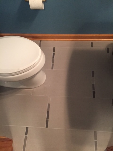 Photo of a transitional powder room in Columbus with a pedestal sink, a two-piece toilet, gray tile, porcelain tile, blue walls and porcelain floors.