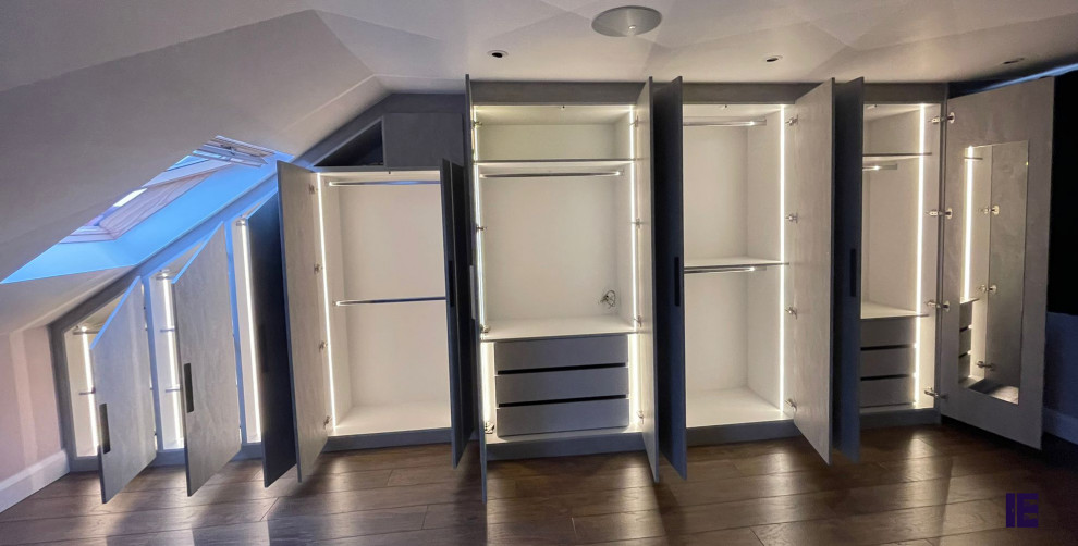 Small modern storage and wardrobe in London with flat-panel cabinets, grey cabinets, plywood floors and wood.