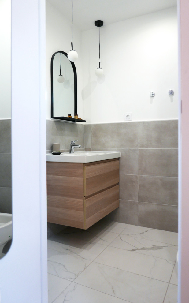 This is an example of a small mediterranean 3/4 bathroom in Marseille with light wood cabinets, a wall-mount toilet, gray tile, marble, laminate floors, a hinged shower door, an enclosed toilet, a single vanity, a floating vanity and exposed beam.