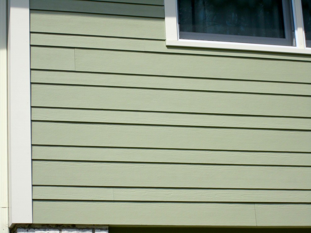 Inspiration for a mid-sized country two-storey green exterior in Chicago with mixed siding.