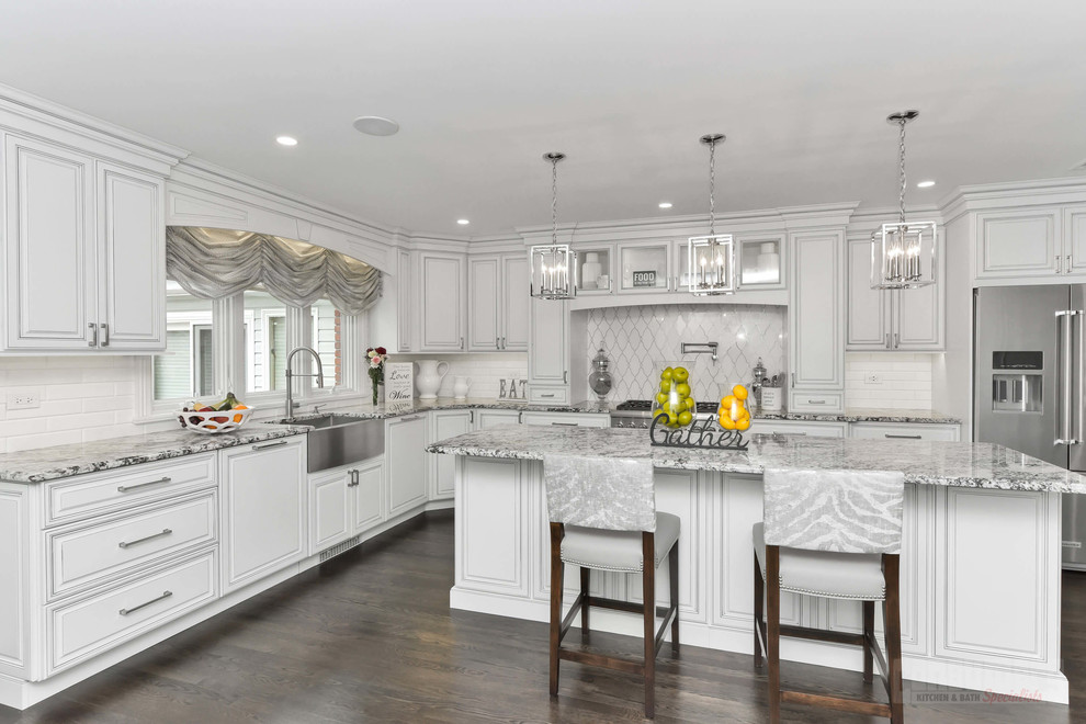 Inspiration for a large l-shaped eat-in kitchen in New York with a farmhouse sink, raised-panel cabinets, white cabinets, granite benchtops, yellow splashback, stainless steel appliances, with island and grey benchtop.