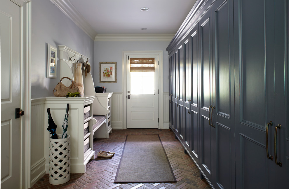 Design ideas for a traditional mudroom in New York with brick floors.