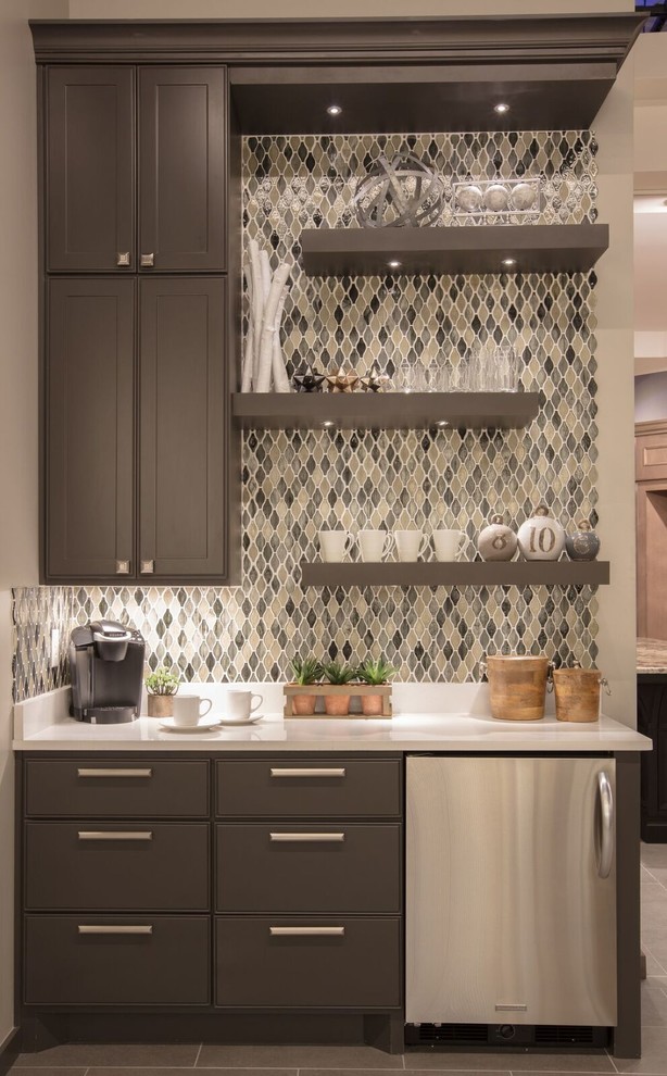 Inspiration for a mid-sized contemporary single-wall wet bar in Austin with shaker cabinets, brown cabinets, quartzite benchtops, beige splashback, porcelain floors, brown floor, no sink, mosaic tile splashback and black benchtop.