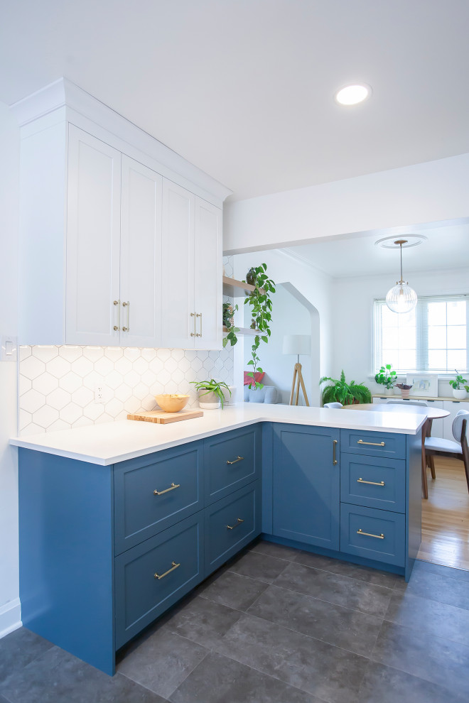 Mid-sized transitional l-shaped eat-in kitchen photo with an undermount sink, blue cabinets, quartz countertops, white backsplash, porcelain backsplash, stainless steel appliances, no island and white countertops
