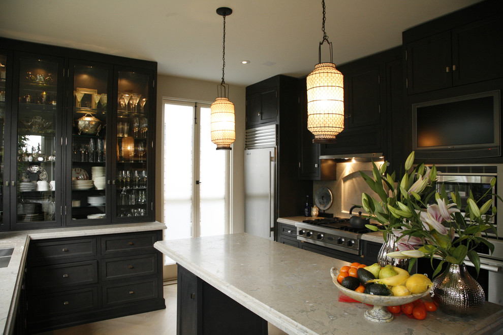 Transitional kitchen in San Francisco with glass-front cabinets, black cabinets and limestone benchtops.