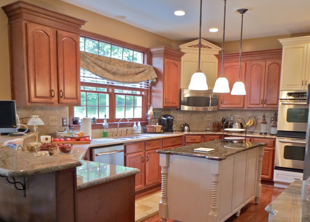 Enclosed kitchen - large traditional u-shaped medium tone wood floor enclosed kitchen idea with a double-bowl sink, raised-panel cabinets, medium tone wood cabinets, granite countertops, beige backsplash, stainless steel appliances, yellow walls and an island