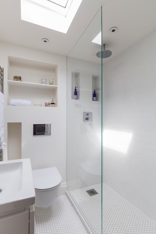 Inspiration for a small transitional master bathroom in London with open cabinets, white cabinets, an open shower, a wall-mount toilet, white tile, white walls, ceramic floors and a wall-mount sink.