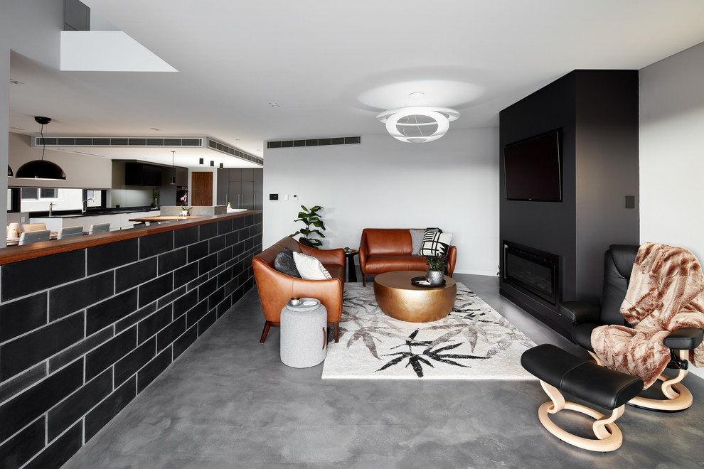 Modern living room in Sydney with grey walls, a standard fireplace and a wall-mounted tv.