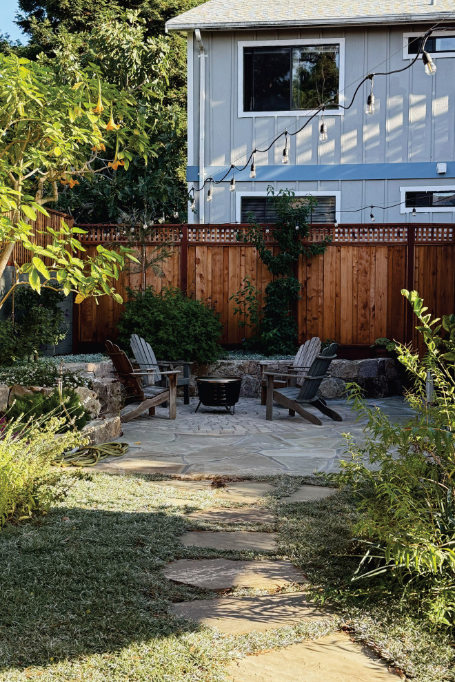 Inspiration for a transitional backyard concrete paver patio remodel in San Francisco with a fire pit and no cover