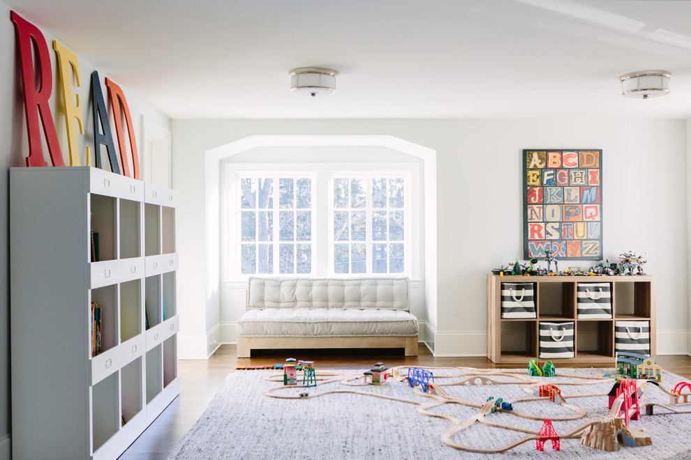 Photo of a transitional gender-neutral kids' playroom for kids 4-10 years old in Chicago with white walls, dark hardwood floors and brown floor.