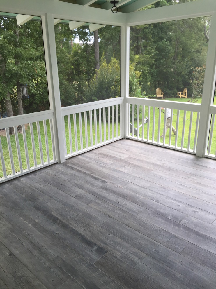 Photo of a mid-sized traditional backyard deck in Charleston with a roof extension.