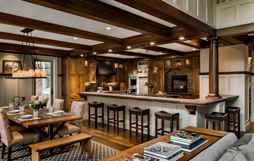 Design ideas for a large arts and crafts u-shaped eat-in kitchen in Boston with dark wood cabinets, granite benchtops, brown splashback, stainless steel appliances, dark hardwood floors, multiple islands, brown floor, grey benchtop and coffered.