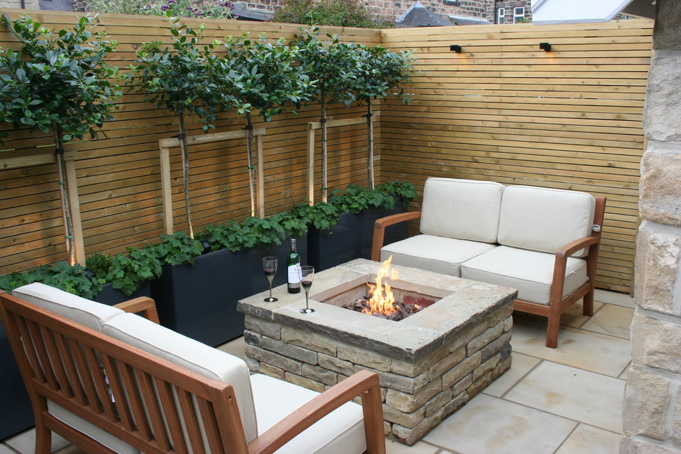Small contemporary backyard patio in Other with a fire feature and no cover.