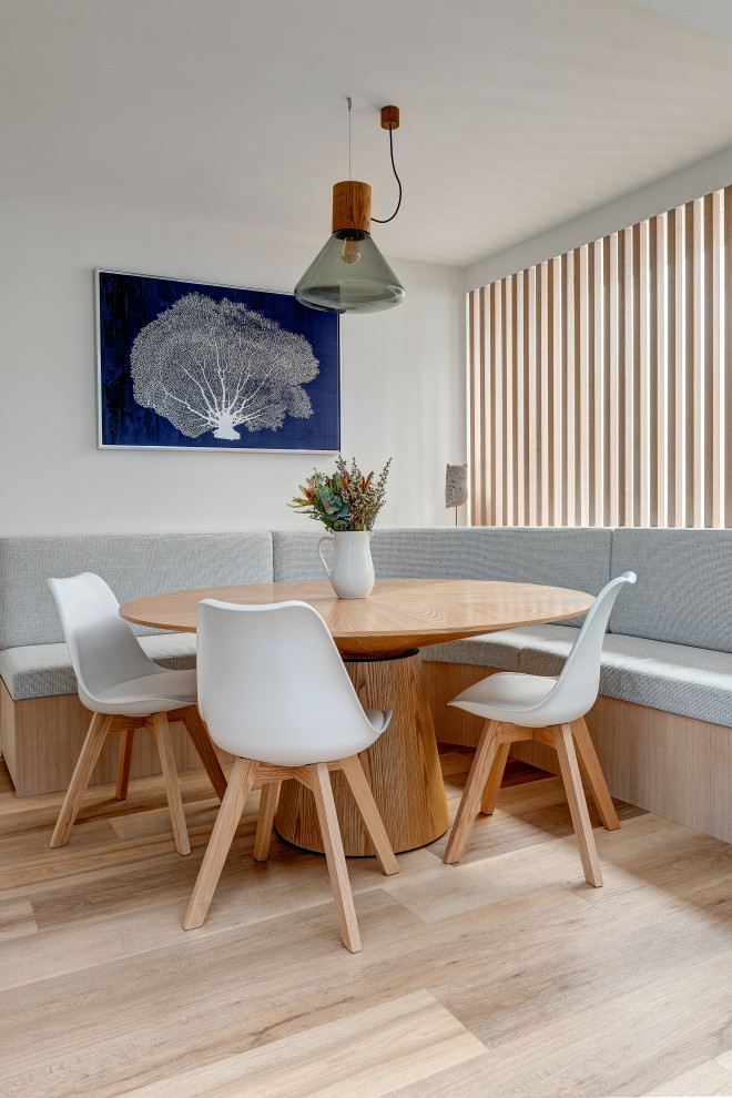 Contemporary dining room in Sydney with grey walls, light hardwood floors and beige floor.
