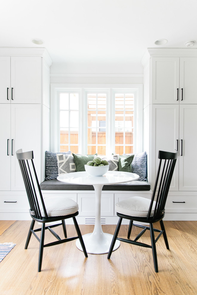 Mid-sized transitional galley medium tone wood floor and brown floor eat-in kitchen photo in Denver with a farmhouse sink, shaker cabinets, green cabinets, quartz countertops, white backsplash, brick backsplash, stainless steel appliances, a peninsula and white countertops