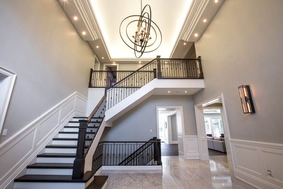 Example of a huge transitional marble floor and gray floor entryway design in Toronto with a brown front door