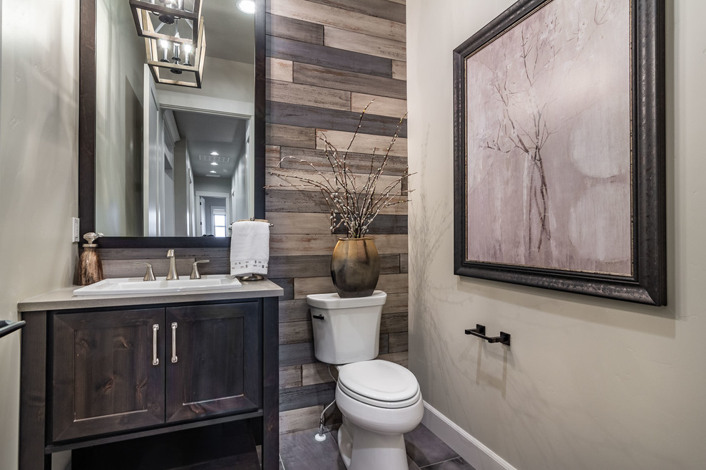 Country powder room in Boise with shaker cabinets, dark wood cabinets, a two-piece toilet, grey walls, a drop-in sink, grey floor and grey benchtops.