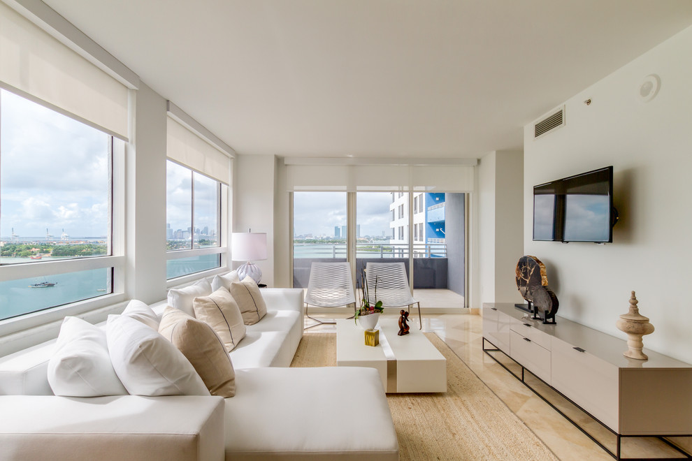 This is an example of a mid-sized modern open concept living room in Miami with white walls, marble floors and beige floor.