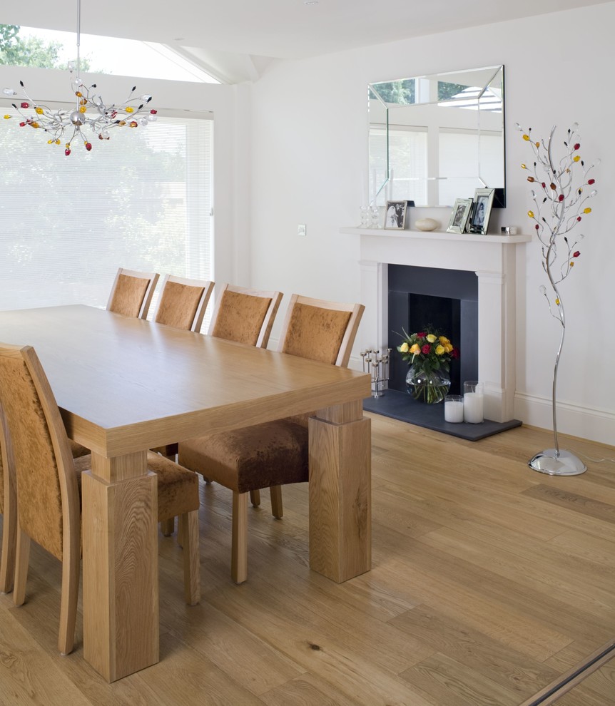 Contemporary dining room in Cambridgeshire with yellow walls.