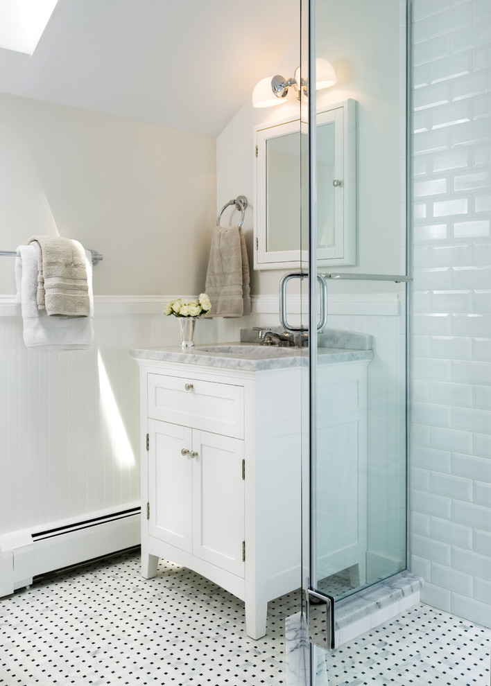 This is an example of a traditional bathroom in DC Metro with marble benchtops, mosaic tile and black and white tile.
