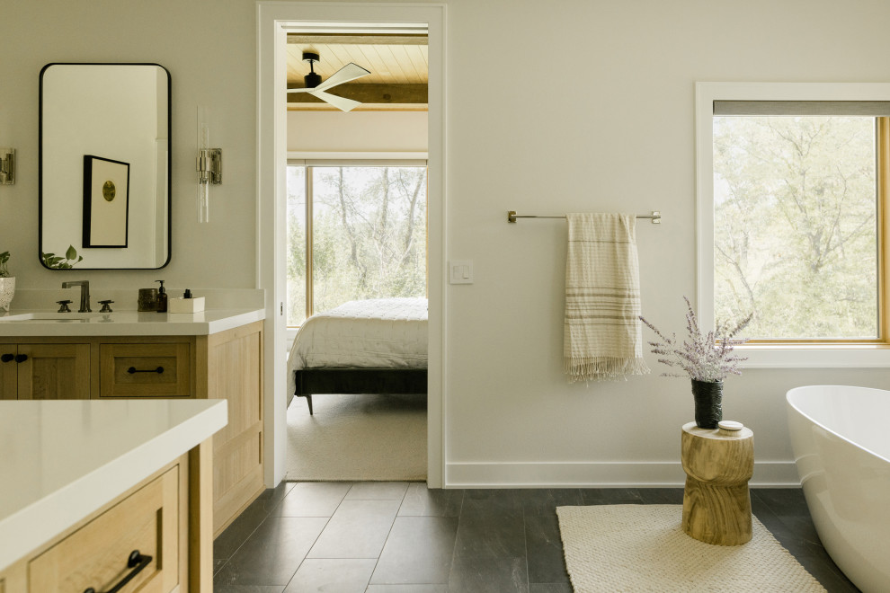 Klassisk inredning av ett stort vit vitt en-suite badrum, med luckor med infälld panel, skåp i ljust trä, ett fristående badkar, en öppen dusch, vit kakel, keramikplattor, grå väggar, klinkergolv i keramik, ett undermonterad handfat, bänkskiva i kvarts, svart golv och dusch med gångjärnsdörr