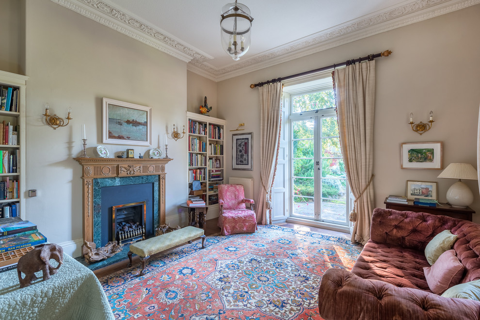 Inspiration for a medium sized victorian enclosed living room in Devon with a reading nook, beige walls, carpet, a two-sided fireplace, a stone fireplace surround and no tv.