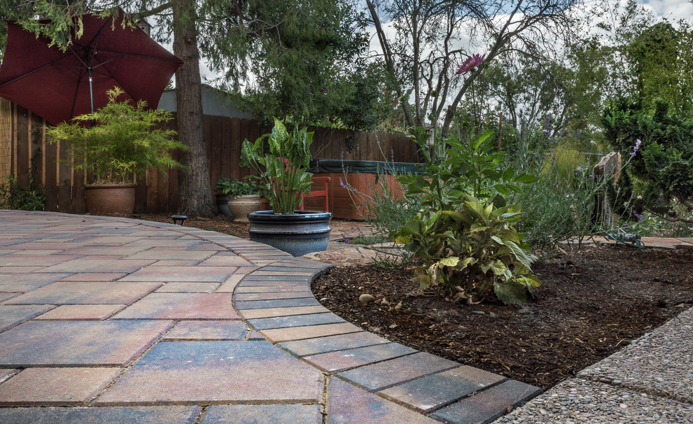 Inspiration for a small craftsman full sun backyard concrete paver formal garden.