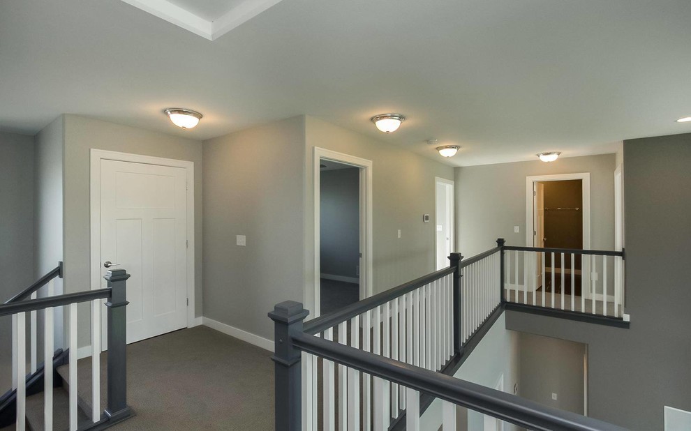 This is an example of a mid-sized contemporary hallway in Cedar Rapids with grey walls, carpet and grey floor.