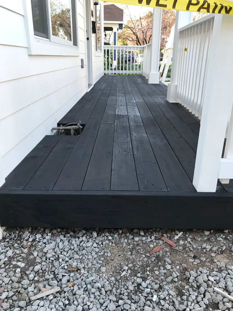 Black stained deck next to a white rail and a wood siding - Modern ...