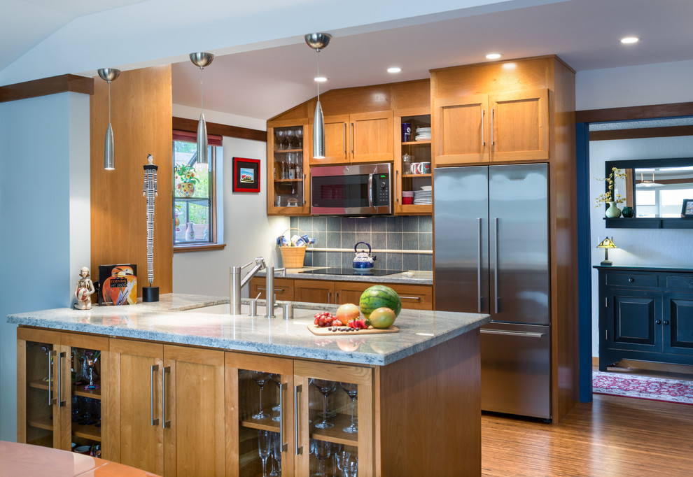 This is an example of a small transitional galley kitchen pantry in San Francisco with an undermount sink, shaker cabinets, light wood cabinets, granite benchtops, blue splashback, porcelain splashback, stainless steel appliances, bamboo floors and a peninsula.