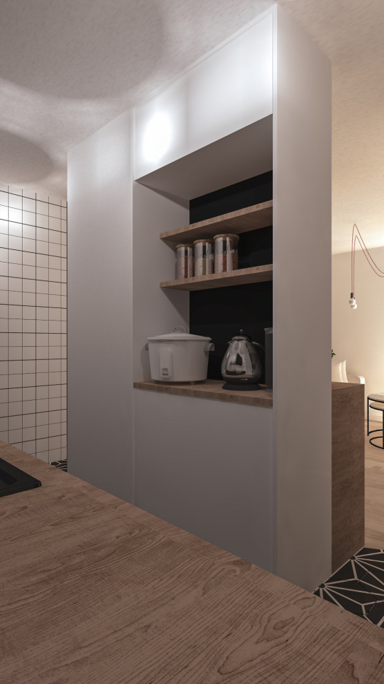 This is an example of a small industrial single-wall open plan kitchen in Lyon with a drop-in sink, beaded inset cabinets, black cabinets, wood benchtops, white splashback, porcelain splashback, panelled appliances, cement tiles, with island, black floor and beige benchtop.