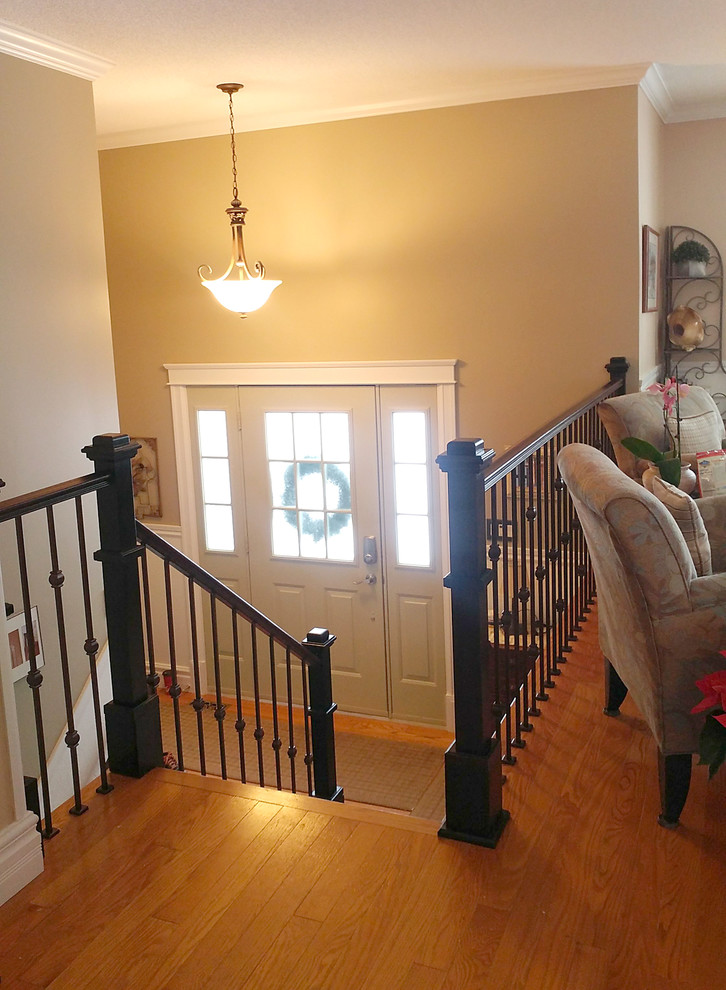 Inspiration for a mid-sized transitional wooden straight wood railing staircase remodel with wooden risers