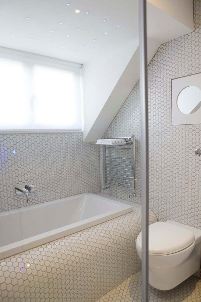 Design ideas for a modern bathroom in London with a wall-mount toilet, mosaic tile and mosaic tile floors.