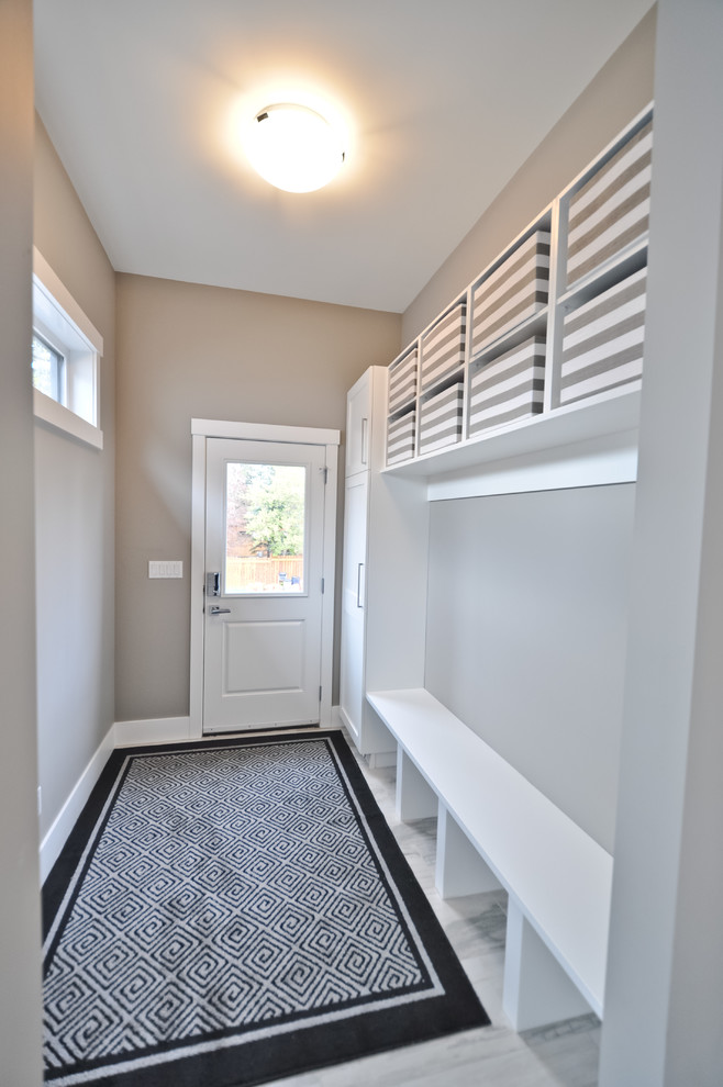 Example of a mid-sized transitional ceramic tile and gray floor mudroom design in Edmonton with gray walls and a black front door